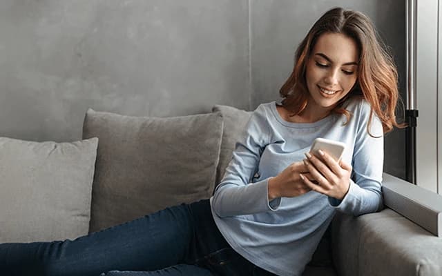 Smiling woman creating a letter of explanation for her mortgage application